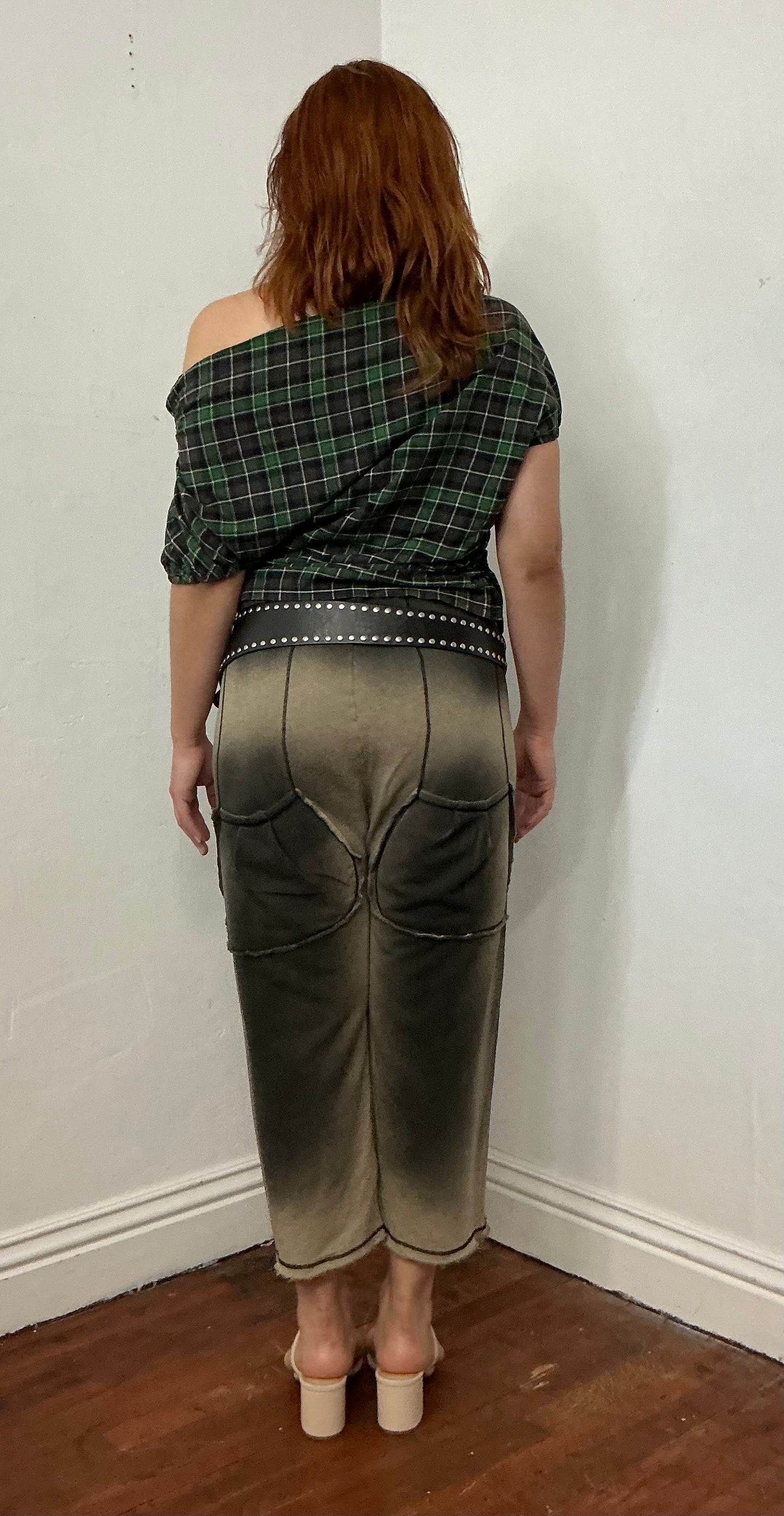 Asymmetrical off shoulder rushed plaid top with a mineral wash.