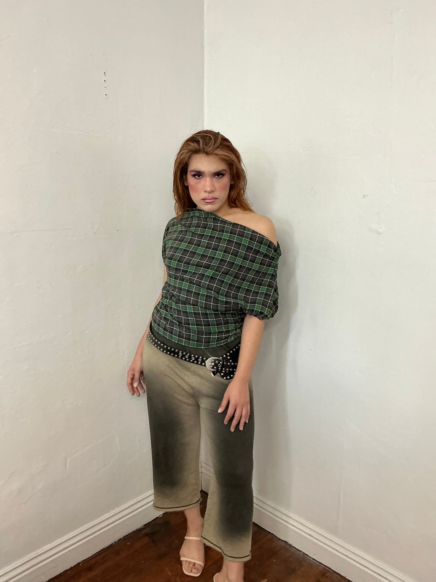 Asymmetrical off shoulder rushed plaid top with a mineral wash.